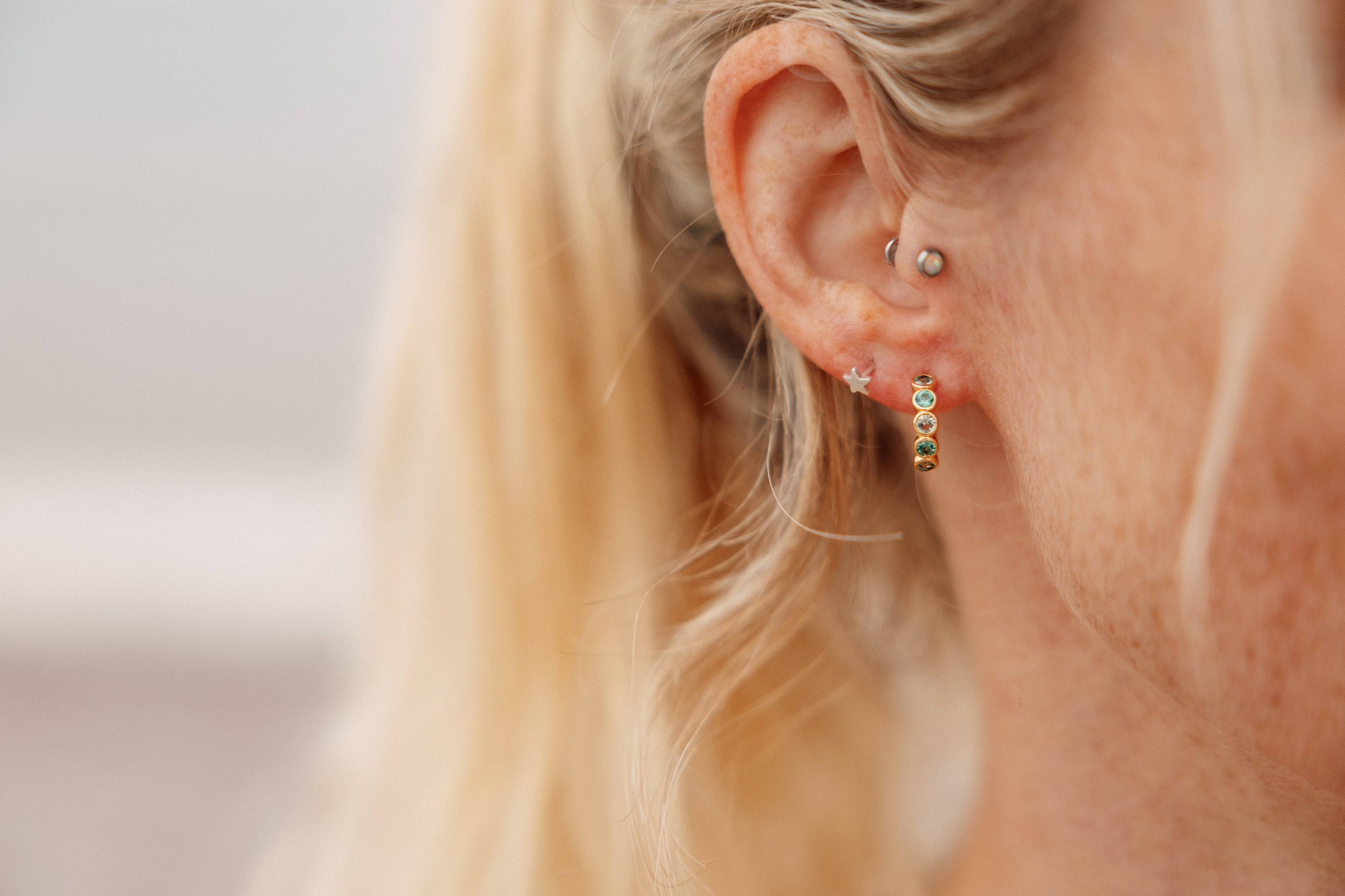 Green gemstone huggie hoops